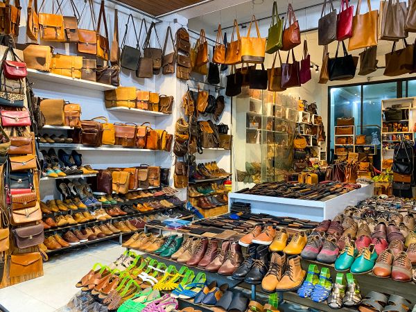 Hoi An Leather shop with myriad shoes and bags on display show the types of goods you can buy in Hoi An