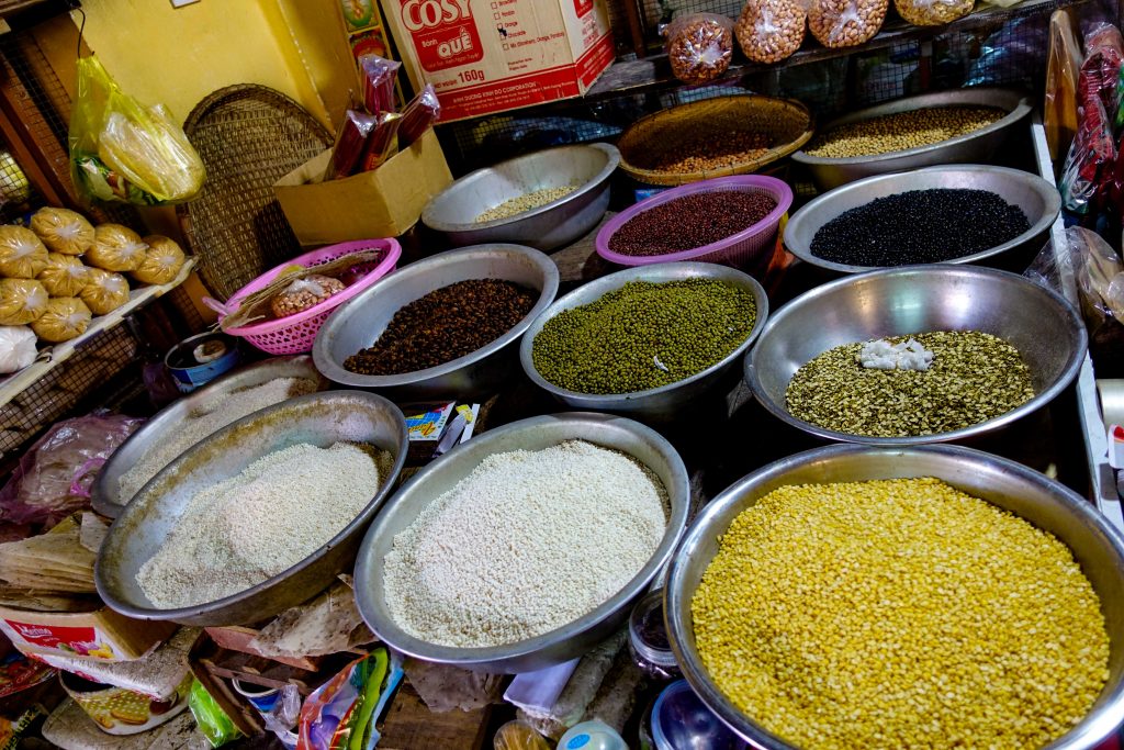 Yellow, red, brown, white spice in bowls at Hoi An Central Market
