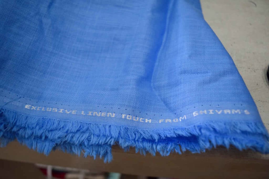 A swatch of Blue linen provides an example of the superior quality fabric at The Tailory, one of Hoi An's Best Tailors.
