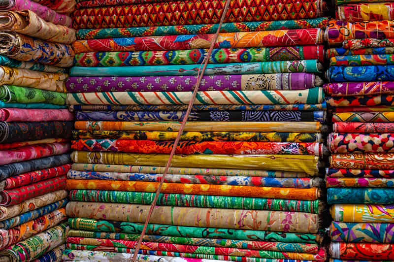Showing huge selection of fabric at the Hoi An Cloth Market