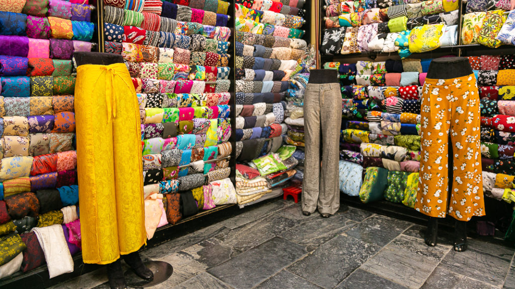 Hoi An Cloth Market showing rows of colourful fabric.