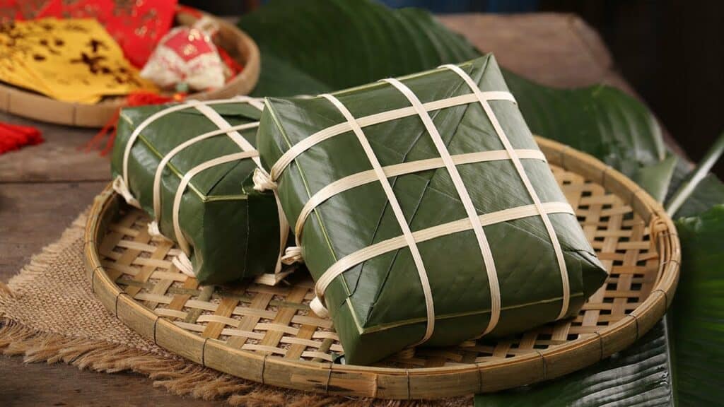 Banh Chung - a sticky rice cake made from glutinous rice, pork, and beans, and wrapped in dong leaves