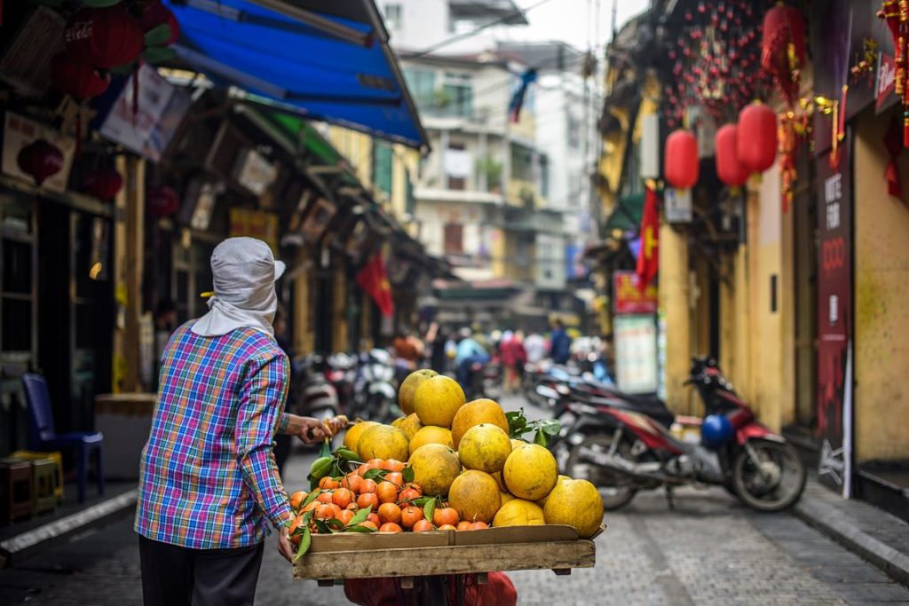 Hoi An's Old Quarter. Woman with fruit. Hanoi to Hoi An