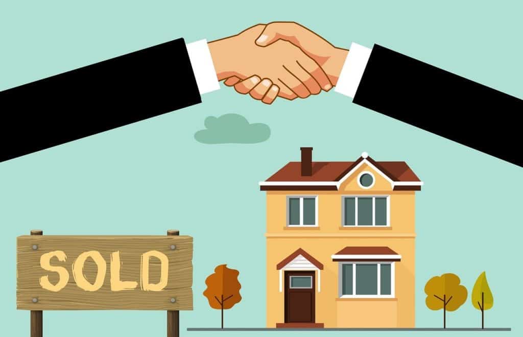 Image of a handshake being done over a house sale