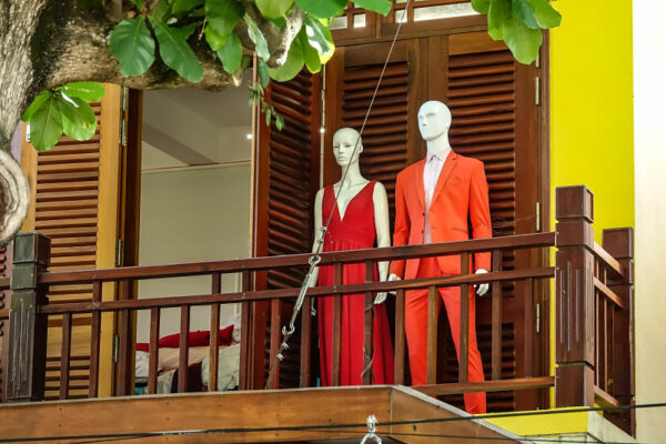 Like the two mannequins on a balcony looking down on the street, Hoi An Now's tailoring article looks at tailors in Hoi An and guides you to find the best.