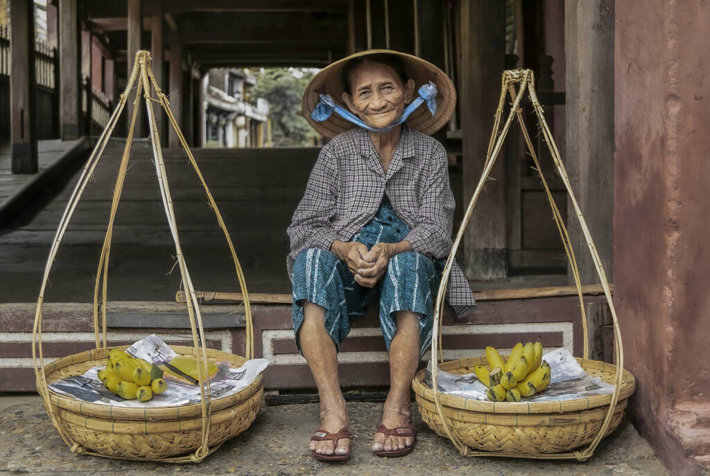 Hoi An Old Town. Lady with bananas by Japanese Bridge