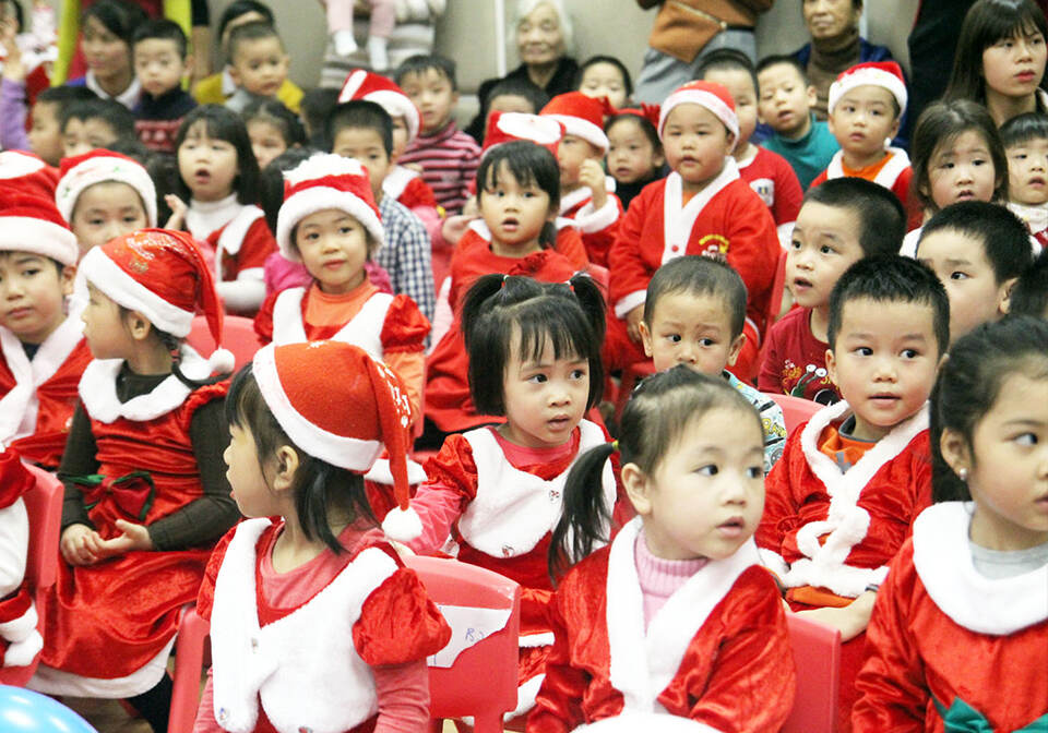 At Christmas in Vietnam it's no surprise to see local children in Santa outfits